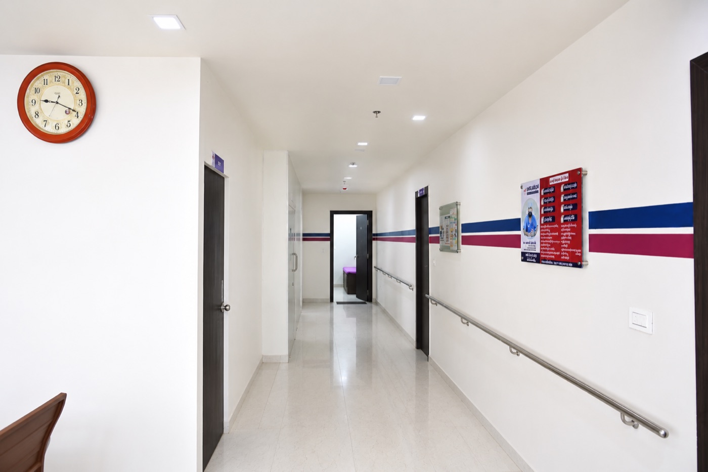 Clean, well-lit corridor with handrails inside Sharada Hospital